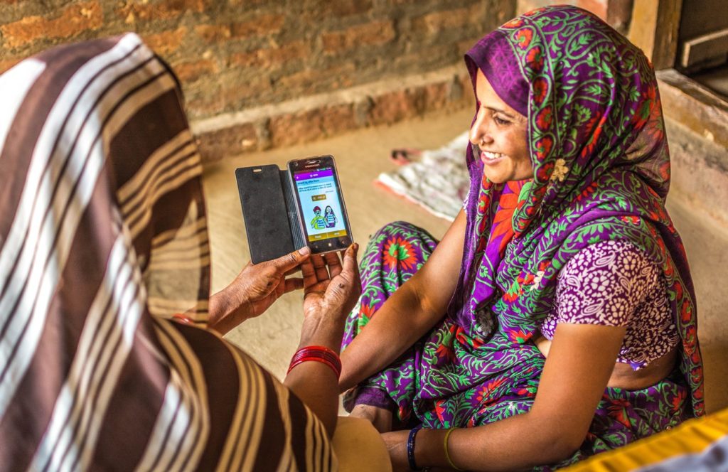 In Uttar Pradesh, India, a frontline health worker counsels a woman on family planning using mSehat, an integrated Android and web-based multimedia-enabled mobile health platform for frontline health workers (FLWs). © 2016 Girdhari Bora /SIFPSA mSehat, Courtesy of Photoshare