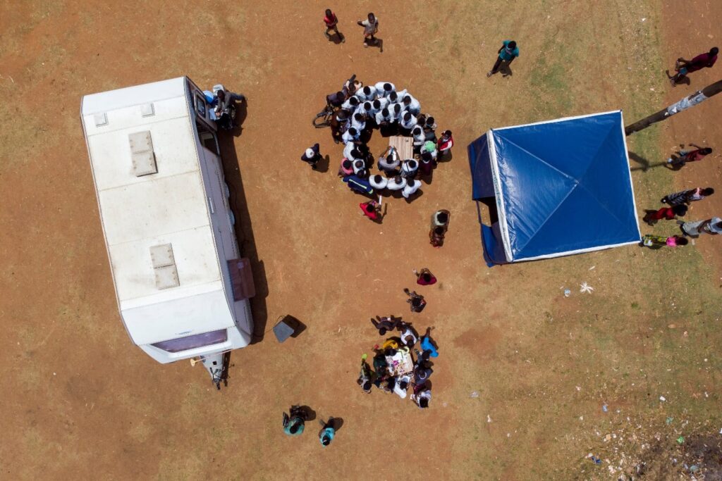 A nurse shows students the variety of contraceptive methods available to them outside of an MSI mobile health clinic